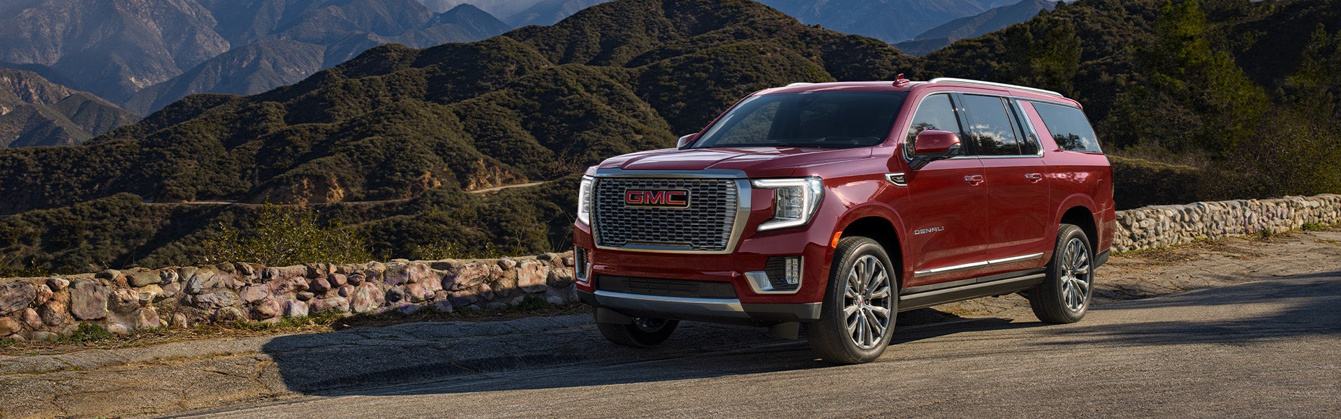 2024 GMC Yukon XL driving on a mountain road